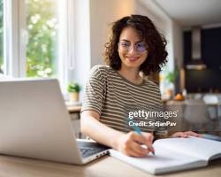 Hình ảnh về Person studying online on a laptop at home
